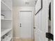 Laundry room features tiled floor, shelving and a coat rack or ironing board hook at 641 Bay Lake Trl, Oldsmar, FL 34677