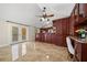 Bright living room featuring vaulted ceilings, tile floors, and an attached kitchen with dark wood cabinets at 641 Bay Lake Trl, Oldsmar, FL 34677