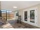 View of an enclosed patio with a rocking chair and french doors leading to the pool deck at 641 Bay Lake Trl, Oldsmar, FL 34677