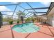 Enclosed pool area with a view of the waterfront, a slide, and outdoor seating at 641 Bay Lake Trl, Oldsmar, FL 34677