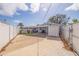 Wide shot of large backyard with covered parking and white privacy fence at 7998 Causeway N Blvd, St Petersburg, FL 33707