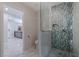 Modern bathroom featuring a glass shower, tiled walls, toilet, and stylish fixtures at 7998 Causeway N Blvd, St Petersburg, FL 33707