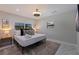 Cozy bedroom with modern ceiling fan, queen bed, and natural lighting from adjacent windows at 7998 Causeway N Blvd, St Petersburg, FL 33707