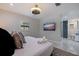 Modern bedroom with decorative ceiling fan, TV, ensuite bathroom featuring a blue mosaic wall and white tiled floors at 7998 Causeway N Blvd, St Petersburg, FL 33707