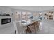 Open dining room featuring a fireplace, large windows, and modern decor in a bright space at 7998 Causeway N Blvd, St Petersburg, FL 33707
