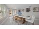 Open dining room features a long table, ample seating, and natural light from surrounding windows at 7998 Causeway N Blvd, St Petersburg, FL 33707