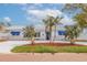 Charming single-story home with lush lawn, palm trees, and a long driveway at 7998 Causeway N Blvd, St Petersburg, FL 33707