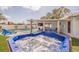 Backyard with private hot tub, heated pool, lounge chairs, and an outdoor dining area at 7998 Causeway N Blvd, St Petersburg, FL 33707