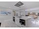 Spacious kitchen showcasing island with bar seating, modern appliances, and open layout to living area at 7998 Causeway N Blvd, St Petersburg, FL 33707