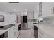 Elegant kitchen with subway tile backsplash, white countertops, and modern stainless steel appliances at 7998 Causeway N Blvd, St Petersburg, FL 33707