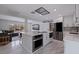 Open kitchen with island, bar seating, stainless steel appliances, and seamless flow to living area at 7998 Causeway N Blvd, St Petersburg, FL 33707