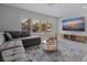 Comfortable living room features a large window, flat-screen TV, and plush sofa at 7998 Causeway N Blvd, St Petersburg, FL 33707