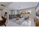 Bright living room featuring marble floors, large windows, and comfortable gray sectional sofa at 7998 Causeway N Blvd, St Petersburg, FL 33707