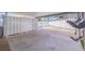 Spacious covered carport with concrete flooring and storage cabinets at 7998 Causeway N Blvd, St Petersburg, FL 33707