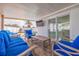 Outdoor covered patio includes comfortable seating and mounted television for relaxing entertainment at 7998 Causeway N Blvd, St Petersburg, FL 33707