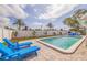 Refreshing pool area complete with lounge chairs, lush landscaping, and privacy fence at 7998 Causeway N Blvd, St Petersburg, FL 33707