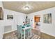 Bright dining area with an adjacent living area, white walls, and matching chairs at 804 Papaya Dr, Tampa, FL 33619