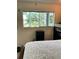 Bright bedroom with a view from the window, a bedside table, and a comfortable bed at 8080 112Th St # 206, Seminole, FL 33772
