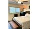 Inviting bedroom with a ceiling fan, bedside lamp, and a cozy bench at 8080 112Th St # 206, Seminole, FL 33772
