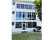 White building with large windows and a glass-enclosed porch, surrounded by lush greenery at 8080 112Th St # 206, Seminole, FL 33772
