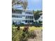 Multi-story white building with large windows and a manicured green lawn at 8080 112Th St # 206, Seminole, FL 33772