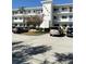 Condo building featuring modern architecture, well-maintained landscaping, and convenient parking at 8080 112Th St # 206, Seminole, FL 33772