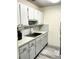 Bright kitchen with white cabinets, stone-look countertops, and modern appliances at 8080 112Th St # 206, Seminole, FL 33772