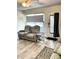 Comfortable living room featuring reclining loveseat, gray window shade and door to the outside at 8080 112Th St # 206, Seminole, FL 33772