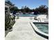 Community pool and hot tub surrounded by lounge chairs, tables, and landscaping at 8080 112Th St # 206, Seminole, FL 33772