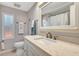 Well-lit bathroom featuring a quartz countertop vanity and large mirror at 845 Jolanda Cir, Venice, FL 34285