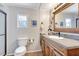 Charming bathroom featuring a wood vanity, granite countertop, and coastal decor at 845 Jolanda Cir, Venice, FL 34285