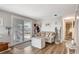 Cozy living room features coastal decor, wood floors, and natural light from the sliding glass door at 845 Jolanda Cir, Venice, FL 34285