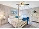 Comfortable main bedroom with four-poster bed, ceiling fan, and bright window views at 845 Jolanda Cir, Venice, FL 34285