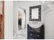 Cozy bathroom featuring a black vanity with a vessel sink and decorative mirror at 864 15Th Ne Ave, St Petersburg, FL 33704
