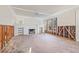Spacious living room with fireplace, abundant natural light, and hardwood floors, ready for renovation at 864 15Th Ne Ave, St Petersburg, FL 33704