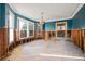 Bright living room with large windows and blue painted walls needing renovation at 864 15Th Ne Ave, St Petersburg, FL 33704