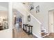 Elegant foyer with hardwood floors, a decorative table, and staircase leading to the upper level at 9315 Knightsbridge Ct, Tampa, FL 33647