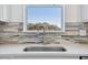 Close-up of a stainless steel kitchen sink and a modern tile backsplash at 9429 Shorebird Ct, Parrish, FL 34219