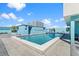 Rooftop pool with stylish lounge furniture, blue skies, and modern architectural accents at 1 Beach Se Dr # 2414, St Petersburg, FL 33701