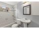 Well-lit bathroom with white subway tiles, a pedestal sink, and modern fixtures at 10410 114Th Ave, Largo, FL 33773