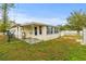 Rear exterior view of home with sun room at 10410 114Th Ave, Largo, FL 33773