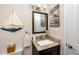 Bathroom with a granite countertop, dark wood vanity, and nautical themed decorations at 11045 Broadwood N Dr, Pinellas Park, FL 33782