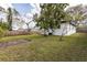 Spacious backyard with lawn, trees, and wood fence at 1316 Barry St, Clearwater, FL 33756