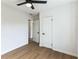 Bright bedroom features neutral walls, modern ceiling fan, and wood-look flooring at 1316 Barry St, Clearwater, FL 33756