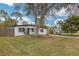 Well-maintained single story home on a green lawn with a mature tree in the yard at 1316 Barry St, Clearwater, FL 33756