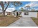 Charming single-story home with a well-maintained lawn, brick walkway, and driveway at 1316 Barry St, Clearwater, FL 33756