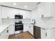 This modern kitchen features white cabinets, stainless steel appliances, and sleek countertops at 1316 Barry St, Clearwater, FL 33756