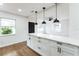 Modern kitchen featuring marble countertops, white cabinets and dark hardware at 1316 Barry St, Clearwater, FL 33756