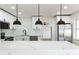 Modern kitchen featuring stainless steel appliances, white cabinets, and a marble breakfast bar at 1316 Barry St, Clearwater, FL 33756