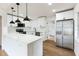Modern kitchen featuring stainless steel appliances, white cabinets, and marble countertops at 1316 Barry St, Clearwater, FL 33756
